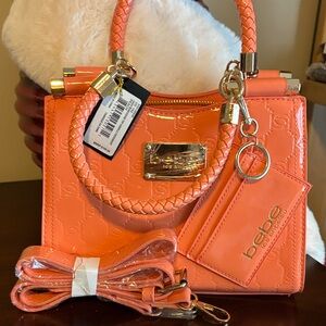 NWT Bebe Dana Monogram
Top Handle Peach Crossbody bag with gold hardware.